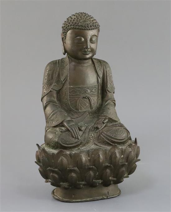 A Chinese bronze seated figure of Buddha Shakyamuni, 17th century, H. 32cm